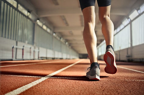 What do top colleges consider important? Runner's legs visible on an indoor track.