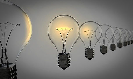 Priorities in College Admissions. Lightbulbs on a grey background.